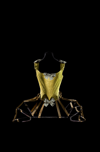 Whalebone corset. France, ca. 1740–60. Silk satin damask, braided silk, linen bows covered in silk and decorated with metallic thread, whalebone, linen lining. Les Arts Décoratifs, collection Mode et Textile, PR 995.16.1. Articulated pannier. France, ca. 1770. Iron covered with leather, fabric tape. Les Arts Décoratifs, depot du musée national du Moyen Âge-Thermes et hotel de Cluny 2005, Cluny 7875. Photographer: Patricia Canino.