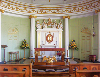Interior view of a private chapel with green walls.